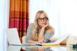 attractive woman writing on laptop