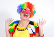Clown looking to the copy space area in a white studio