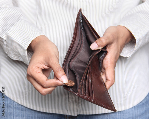 Photo: Person taking a penny from wallet - Bankruptcy Person taking a penny from wallet - Bankruptcy