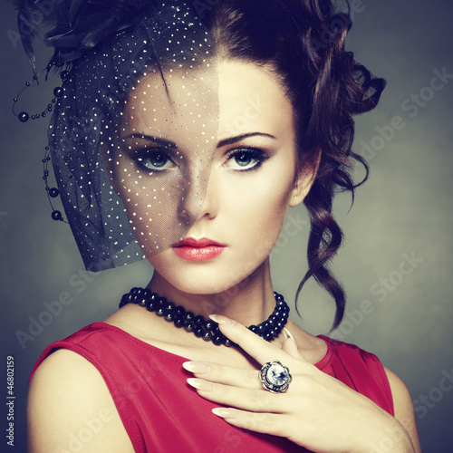 Photo: Retro portrait of a beautiful woman. Vintage style Retro portrait of a beautiful woman. Vintage style