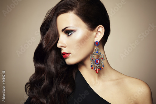 Photo: Portrait of beautiful brunette woman in black dress Portrait of beautiful brunette woman in black dress