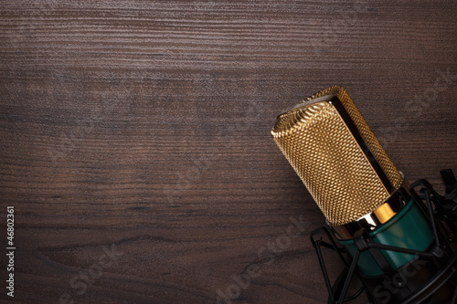 Photo: vintage condensing microphone on the wooden background vintage condensing microphone on the wooden background