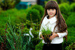 portrait of little girl outdoors in the style of gardener