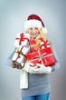 beautiful blonde woman holding a christmas gift is smiling