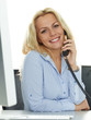 Female office assistant has a call at her work