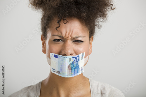 Photo: Covering mouth with a euro banknote Covering mouth with a euro banknote