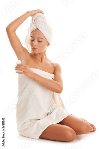 Photo: Woman using deodorant Woman using deodorant