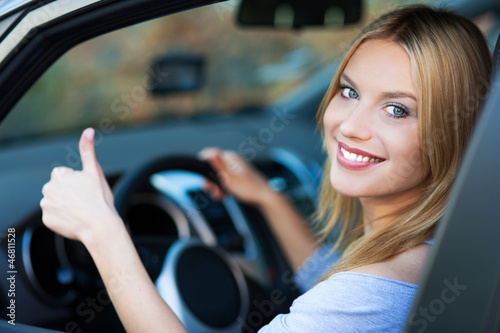 Photo: Woman in car giving thumbs up Woman in car giving thumbs up