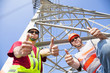 two power line workers with thumbs up