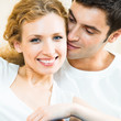 Cheerful smiling young couple, indoors