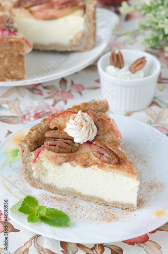 Photo: slice of cheesecake with apples and caramelized pecans vertical slice of cheesecake with apples and caramelized pecans vertical
