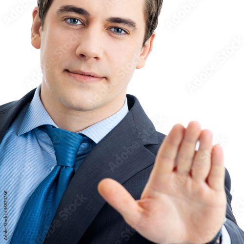 Photo: Serious business man showing stop gesture Serious business man showing stop gesture