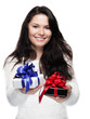 Photo: Young woman hands over two gifts - isolated Young woman hands over two gifts - isolated