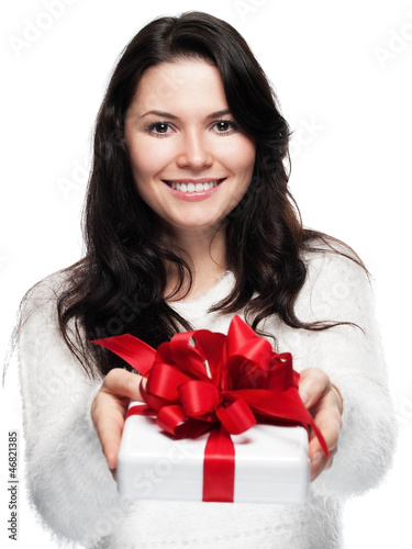 Photo: Young woman hands over a gift - isolated Young woman hands over a gift - isolated
