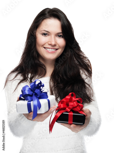 Photo: Young woman hands over two gifts - isolated Young woman hands over two gifts - isolated