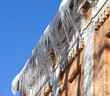 Snow-covered roof with icicles