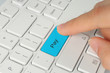 Hand pushing blue pay keyboard button