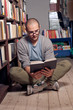Photo: Student reading book in library Student reading book in library