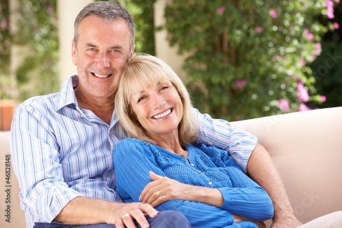 Photo: Senior Couple Relaxing On Sofa At Home Senior Couple Relaxing On Sofa At Home