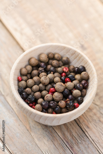 Photo: Pimento and juniper berries and pink peppercorns in a bowl Pimento and juniper berries and pink peppercorns in a bowl