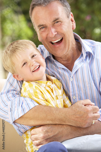Photo: Grandfather And Grandson Relaxing On Sofa Together Grandfather And Grandson Relaxing On Sofa Together