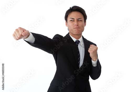 Photo: Young businessman hitting a straight punch Young businessman hitting a straight punch
