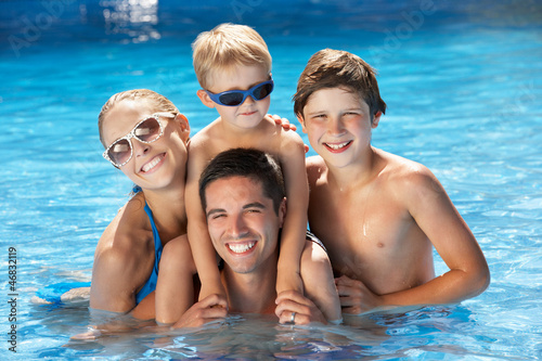 Photo: Family Having Fun In Swimming Pool Family Having Fun In Swimming Pool