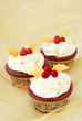 Photo: Christmas cupcakes with gold leaves and red berries Christmas cupcakes with gold leaves and red berries