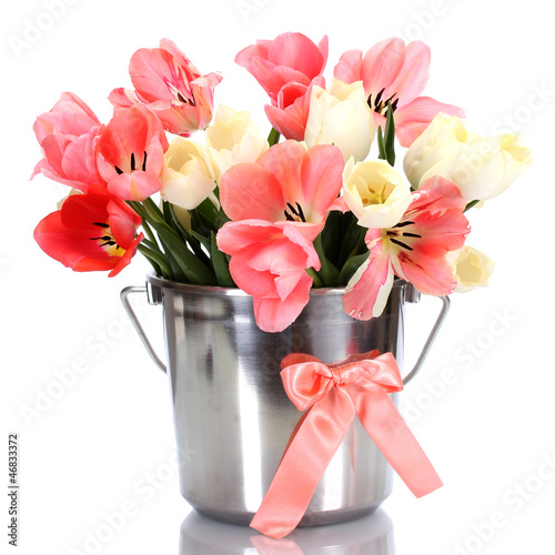 Photo: beautiful pink tulips in bucket isolated on white. beautiful pink tulips in bucket isolated on white.