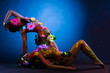 Photo: Nude women with glow uv body art and flowers Nude women with glow uv body art and flowers