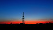 timelapse silhouette of a land drilling rig.