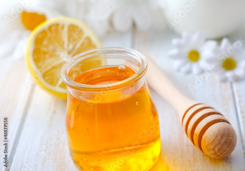 Photo: fresh honey in the glass bank and camomiles fresh honey in the glass bank and camomiles