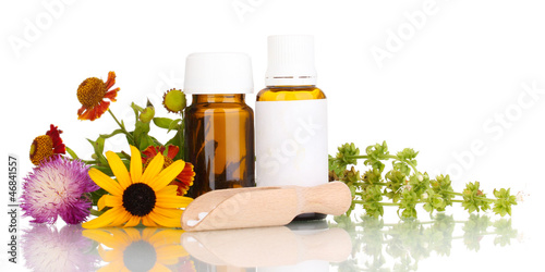 Photo: medicine bottles with tablets and flowers isolated on white medicine bottles with tablets and flowers isolated on white