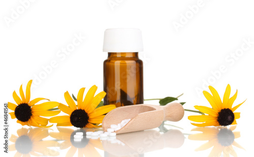 Photo: medicine bottle with tablets and flowers isolated on white medicine bottle with tablets and flowers isolated on white