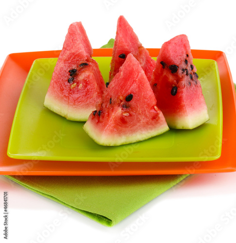 Photo: Sweet watermelon slices on plates isolated on white Sweet watermelon slices on plates isolated on white