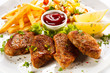 Grilled steaks, French fries and vegetables