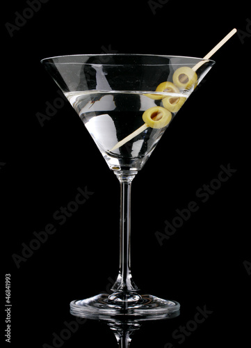 Photo: Martini glass and olives isolated on black Martini glass and olives isolated on black