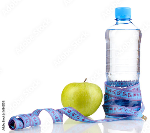 Photo: Bottle of water, apple and measuring tape isolated on white Bottle of water, apple and measuring tape isolated on white
