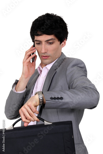 Photo: Businessman trying to stay on schedule Businessman trying to stay on schedule