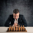 Man playing chess, isolated on dark grunge background.