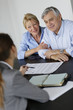 Senior couple meeting architect for building project