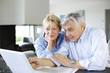 Photo: Senior couple connected with family on internet Senior couple connected with family on internet