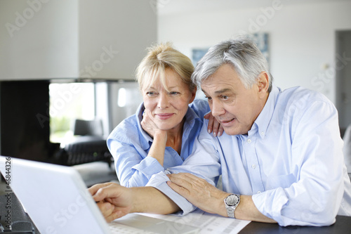 Photo: Senior couple connected with family on internet Senior couple connected with family on internet
