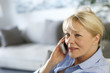 Senior woman at home talking on mobile phone