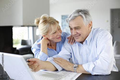 Photo: Senior couple connected with family on internet Senior couple connected with family on internet