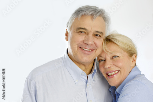 Photo: Portrait of cheerful senior couple at home Portrait of cheerful senior couple at home