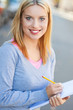Young woman with notebook and pencil