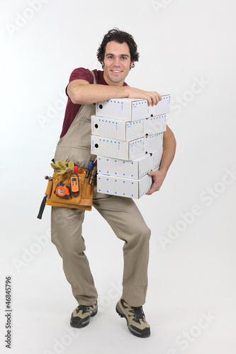 Photo: Man struggling to carry pile of boxes Man struggling to carry pile of boxes