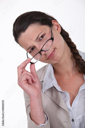 Photo: Woman peering over her glasses Woman peering over her glasses