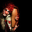 Photo: Evil Horrible Clown Holding Coffin In Darkness Evil Horrible Clown Holding Coffin In Darkness